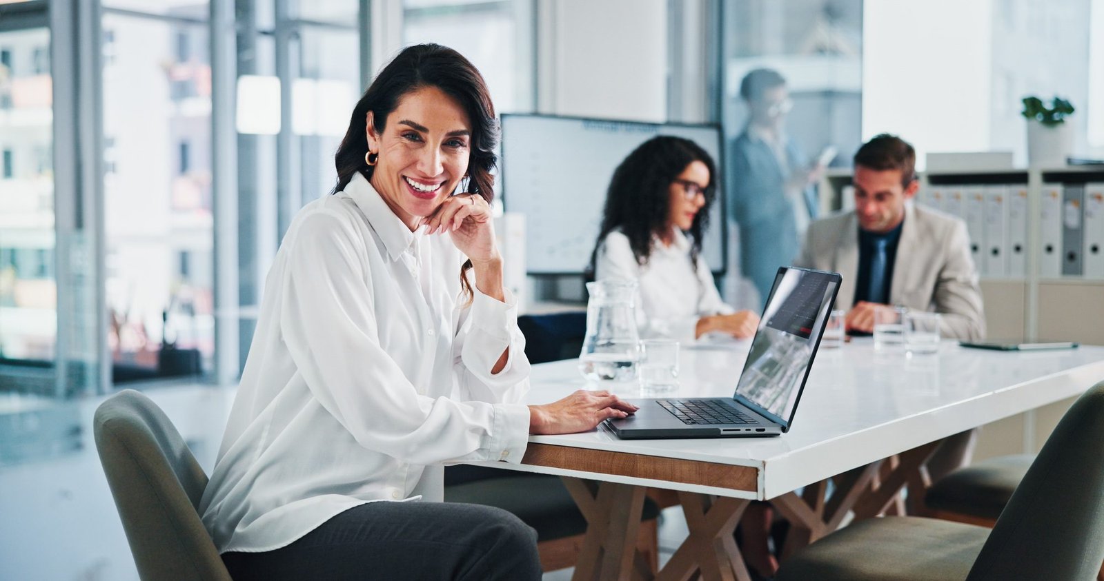 Meeting, businesswoman and portrait with laptop in office, about us or research for stock market. B